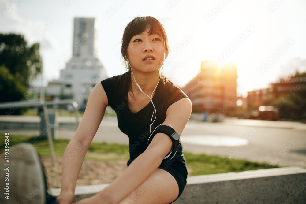 Female runner doing stretching workout