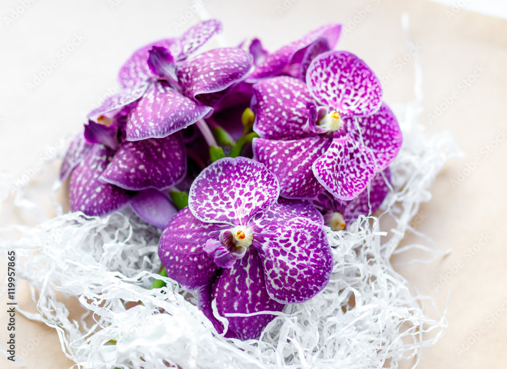 bouquet of purple orchids on craft paper close up