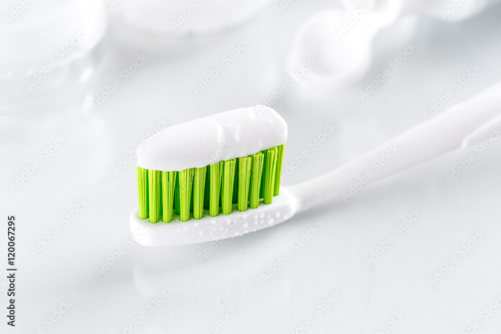 sqweezed toothpaste and toothbrush on white background