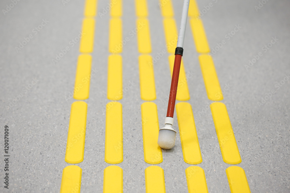 Blind pedestrian walking on tactile paving