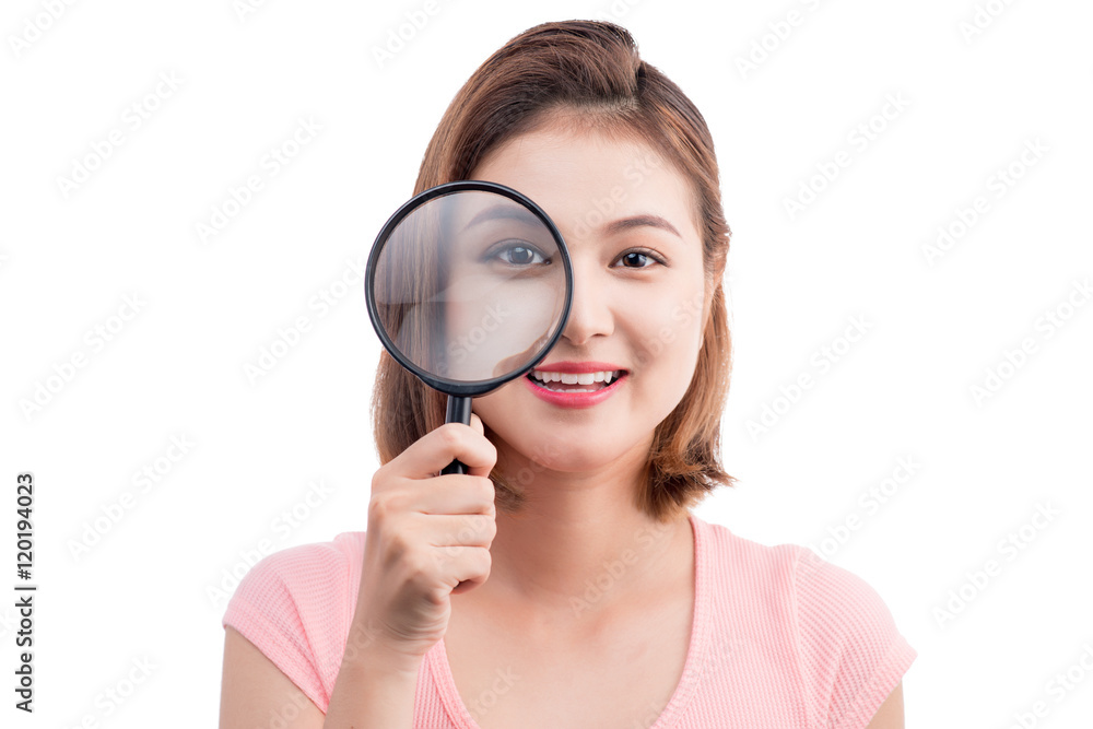 Beautiful asian girl portrait looking through magnifier. Isolate