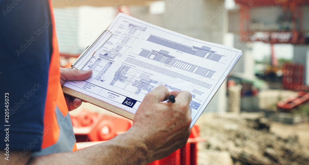 Construction Site Engineerer Working Blueprint