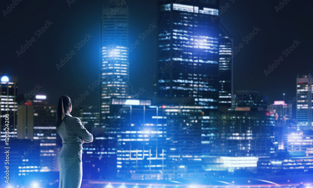 Woman looking at night city