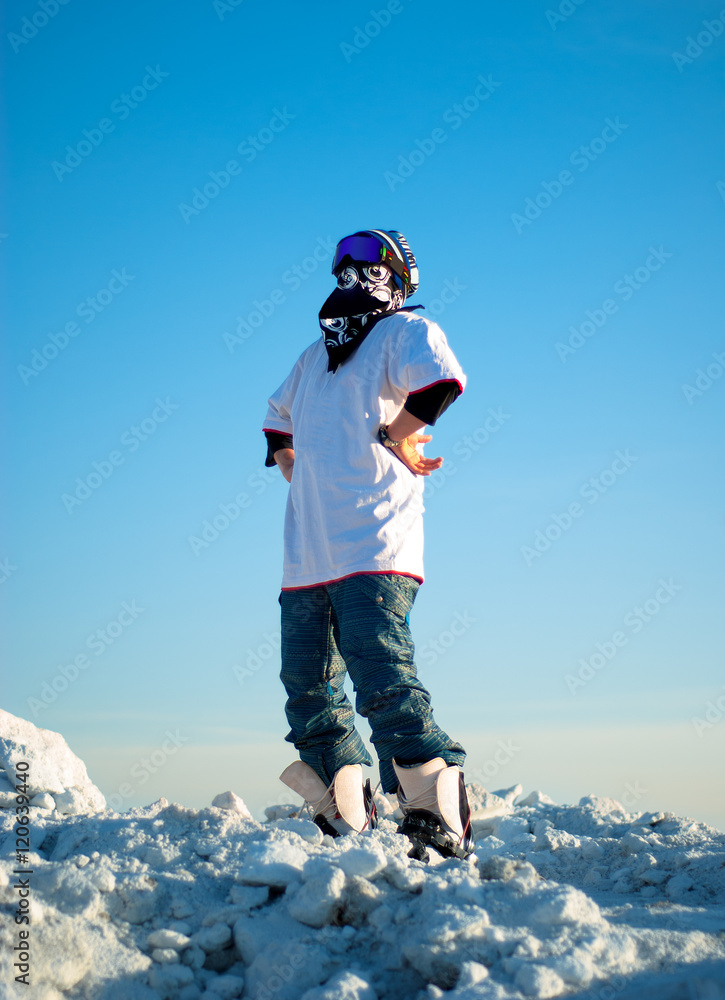 guy in snowboard gear standing on a mountain