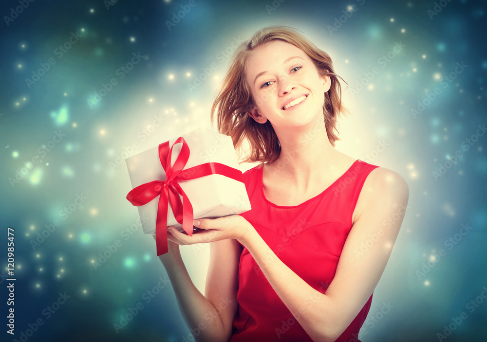 Happy young woman holding a present box