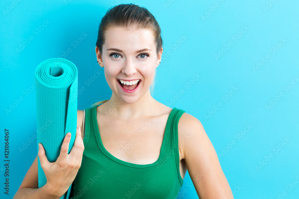 Woman holding yoga mat