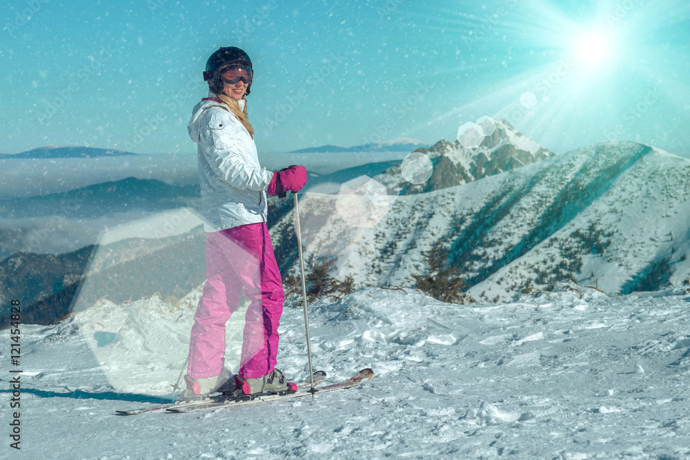 幸福女性在滑雪场停留在美丽的山景上