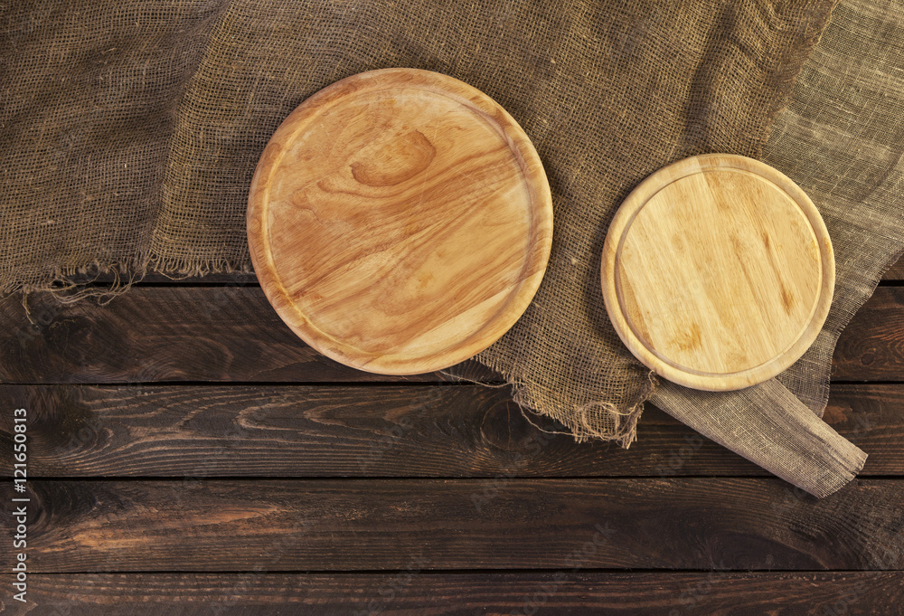 Round cutting board on dark wooden table