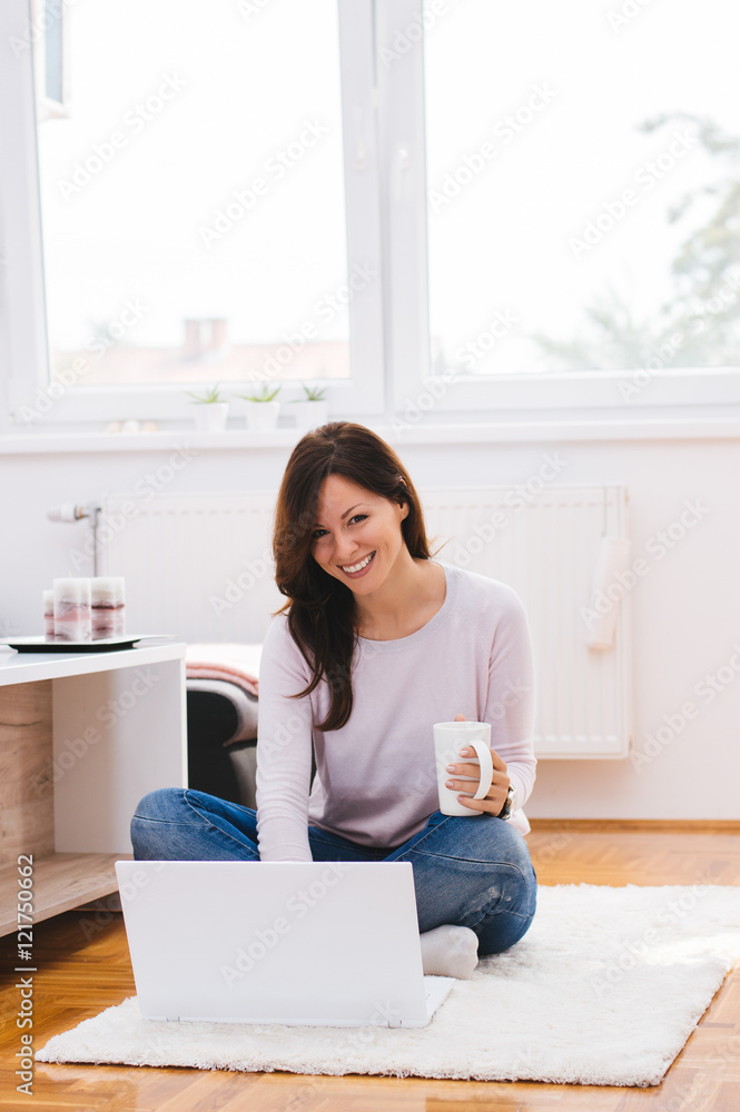 Shot of beautiful woman working at home, drinking a morning coff