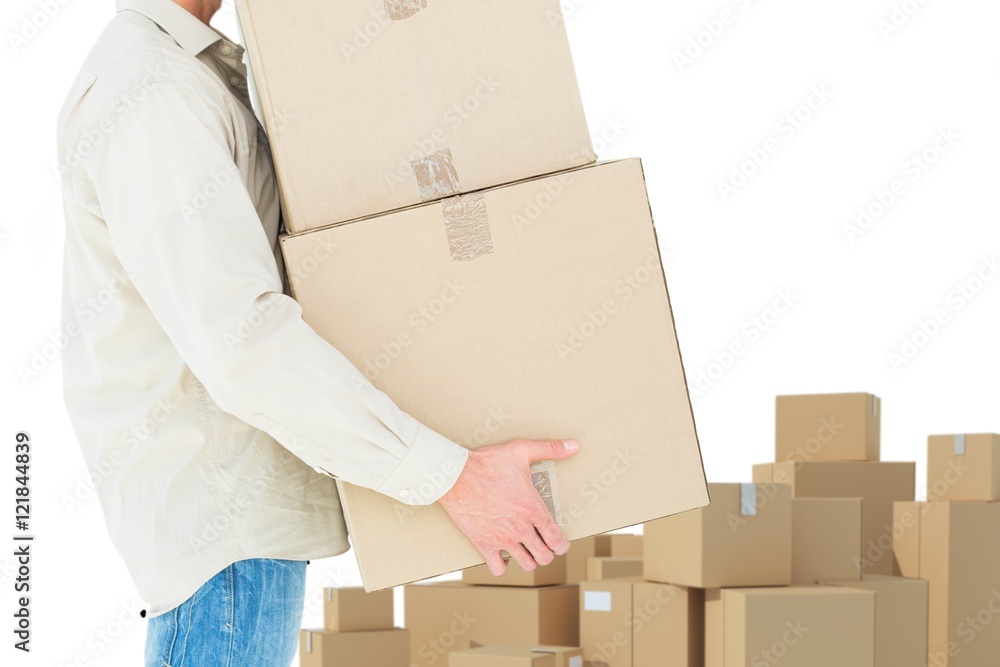 Composite image of delivery man carrying cardboard boxes