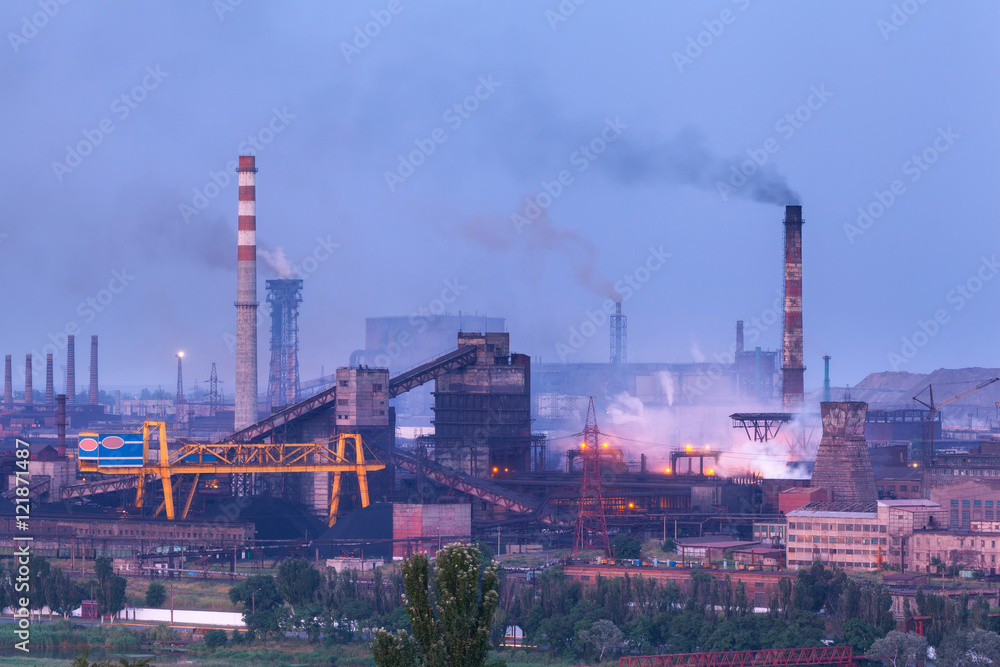 Metallurgical plant at night. Steel factory with smokestacks. Steelworks, iron works. Heavy industry