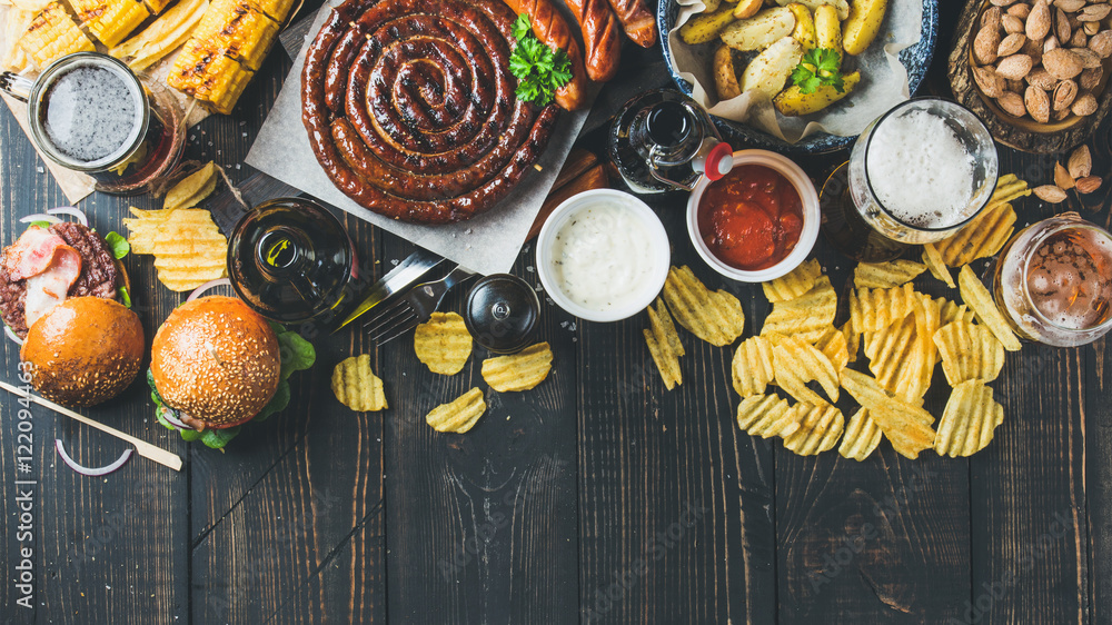 Beer and snack set. Octoberfest food frame concept. Variety of beers, grilled sausages, burgers, cor