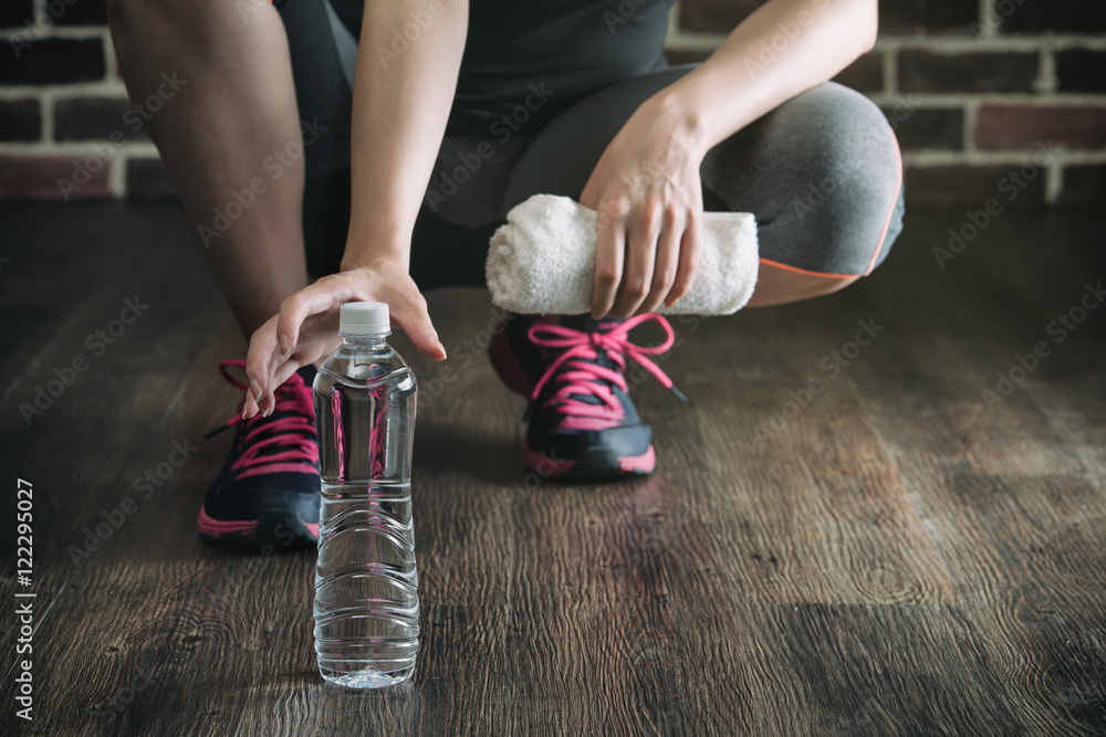 Squat on wooden floor take rest drinking water, healthy lifestyl