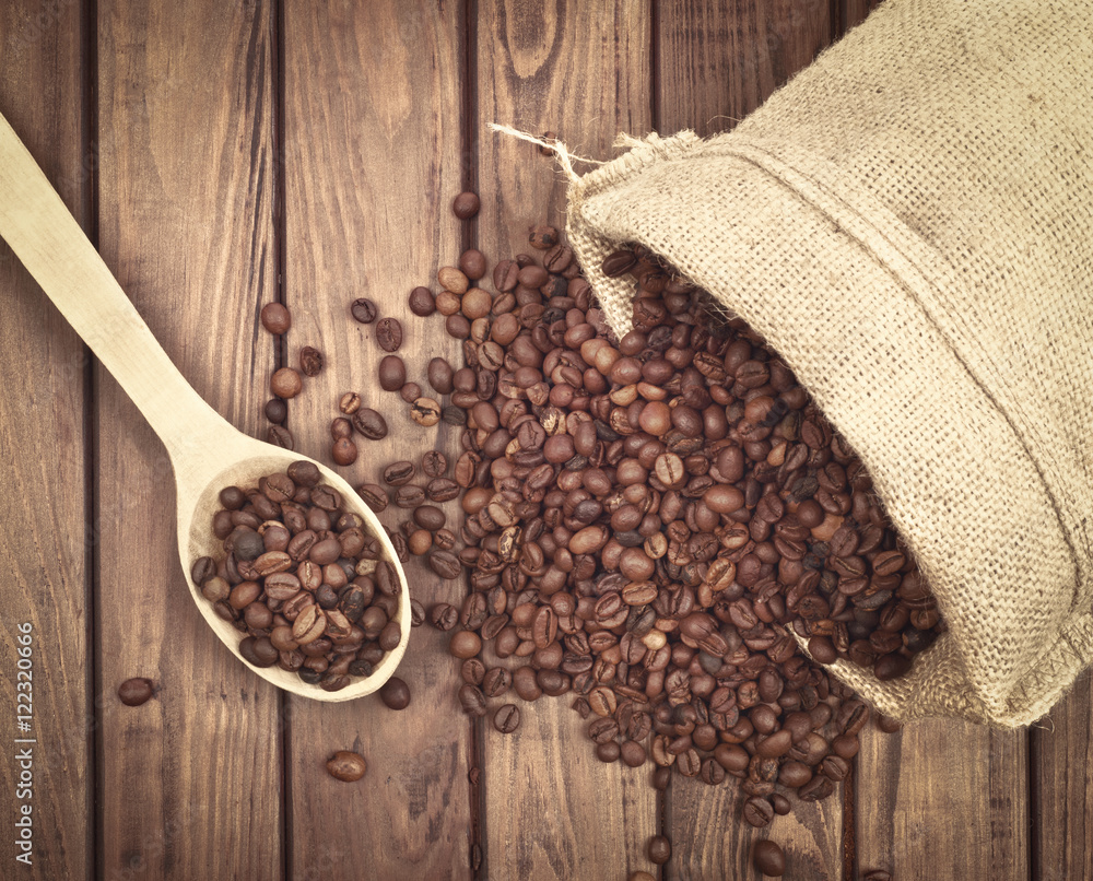 Fresh coffee beans on wood background