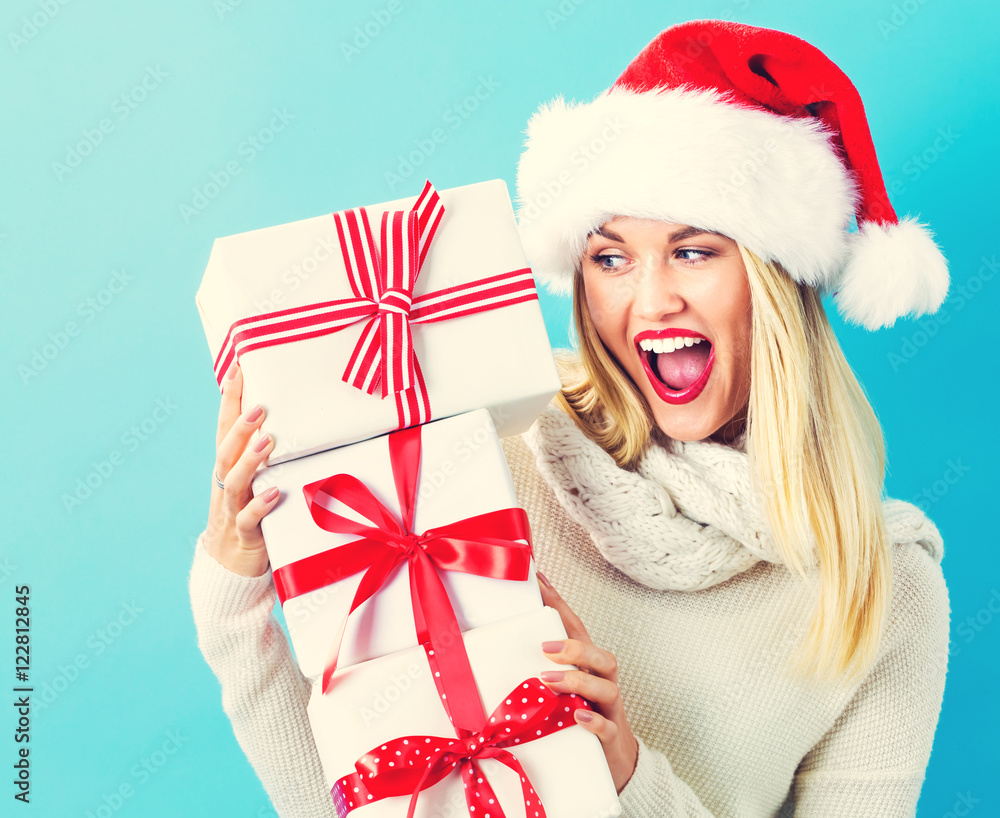 Young woman holding Christmas gifts