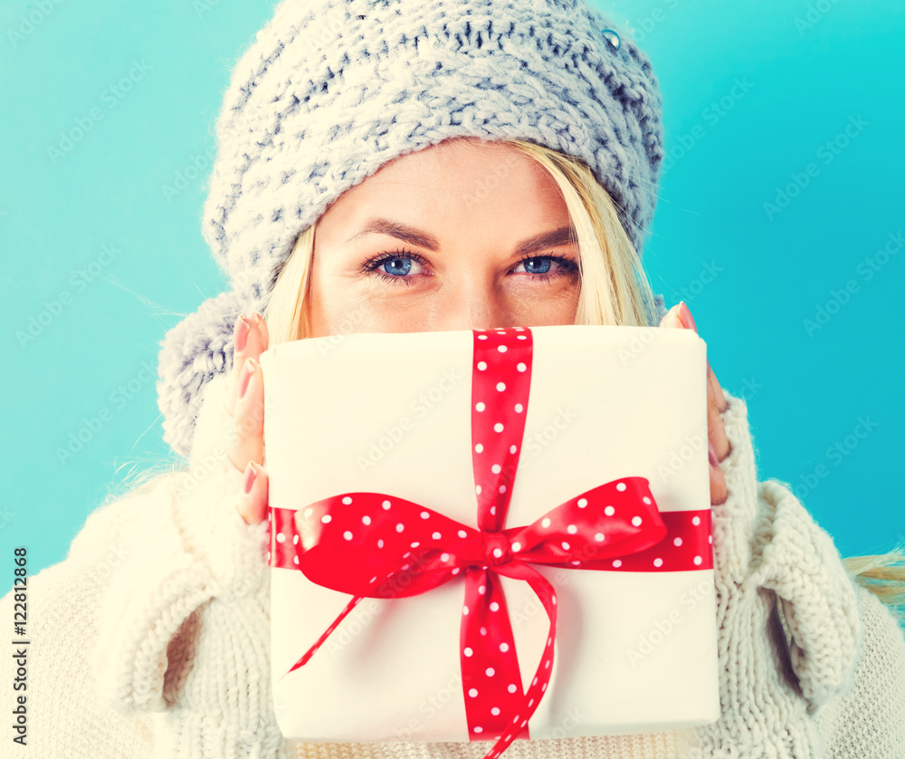 Young woman holding a Christmas gift