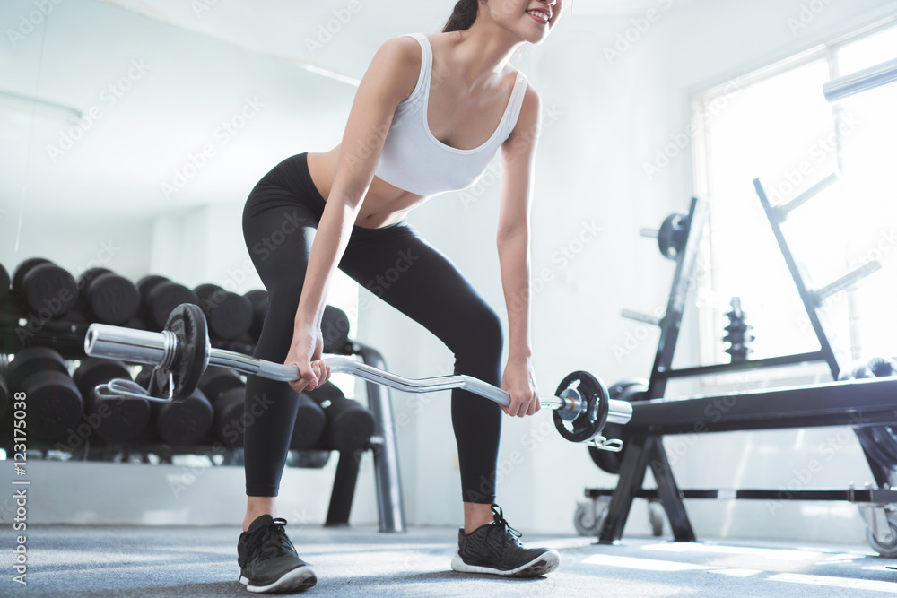 Asian women exercising in the gym, she was pretending to deadli