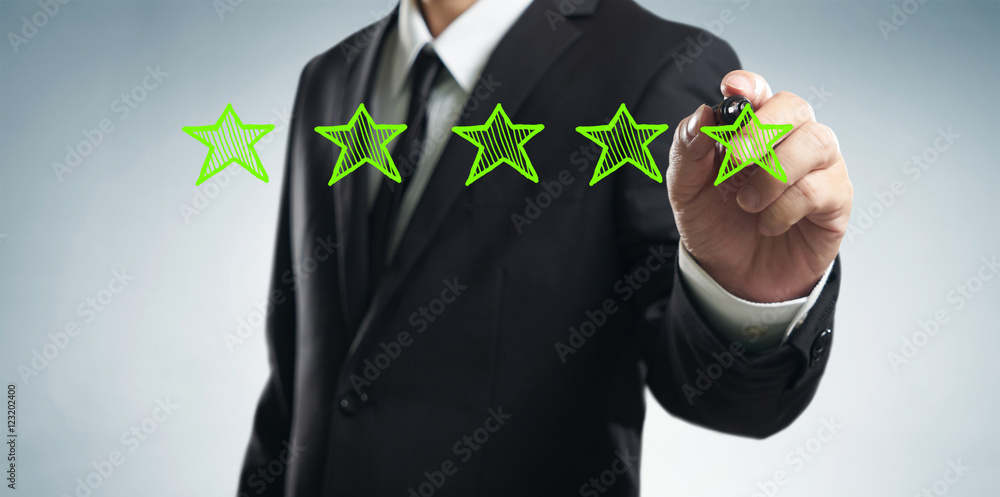 Review, increase rating, performance and classification concept. Businessman draw five green stars t