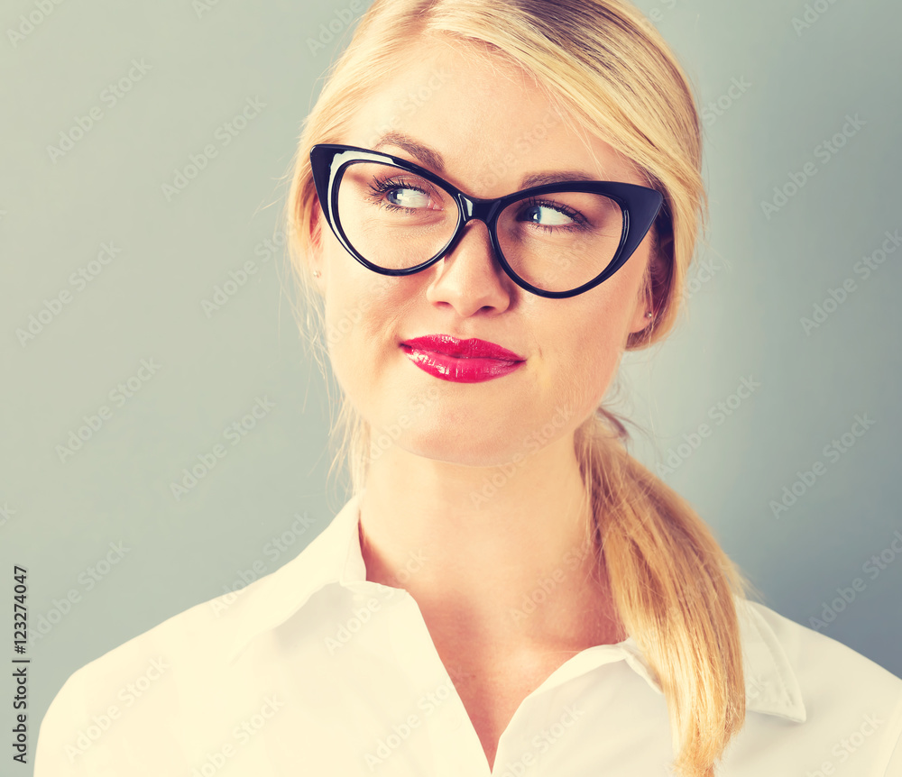 Young blonde businesswoman in black glasses