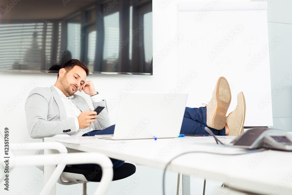 Happy young business man work in modern office