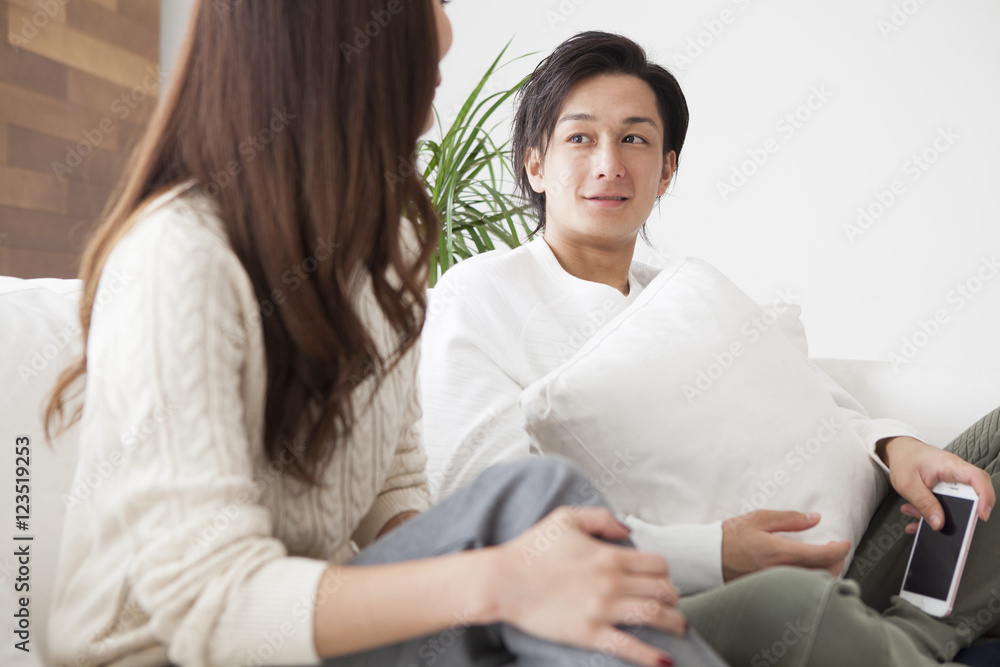 Young couple are talking happily in the living room