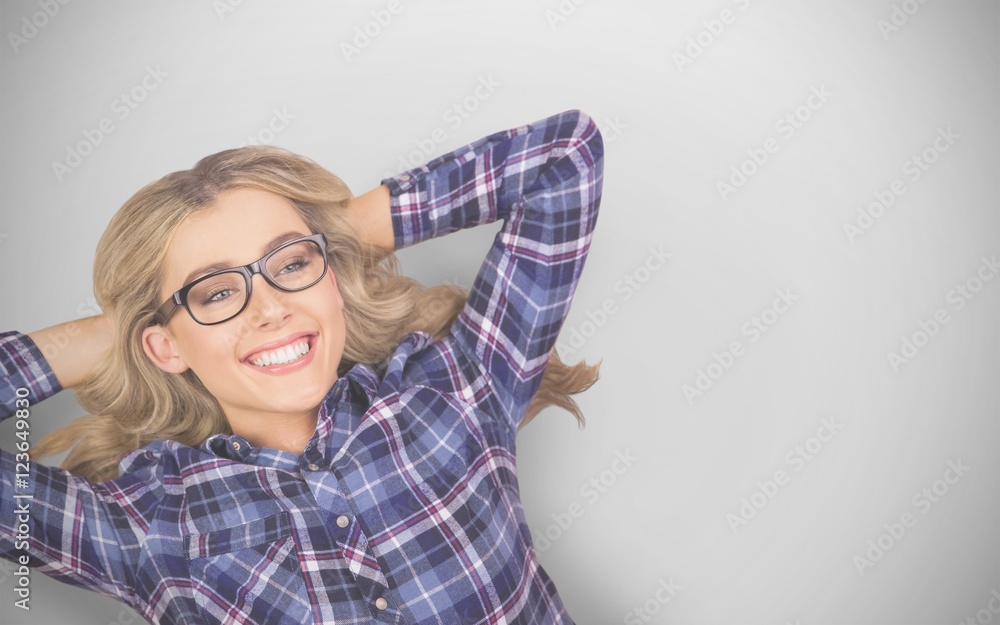 Composite image of a blonde hipster lying on the floor