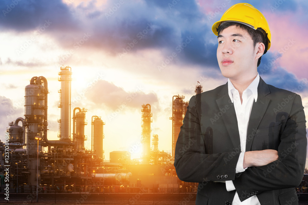 Double exposure of Engineer looking forward in oil refinery