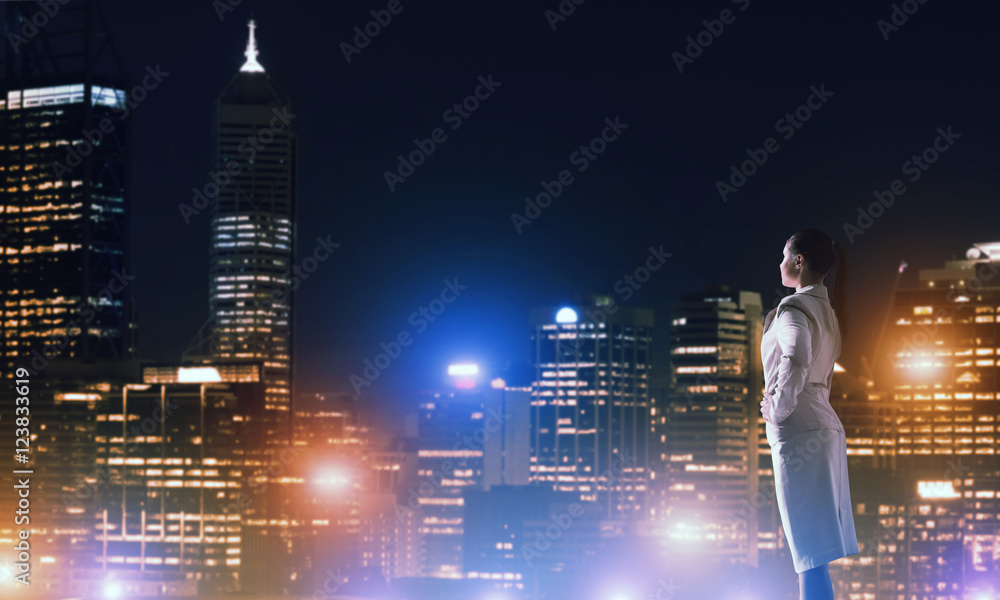 Woman looking at night city