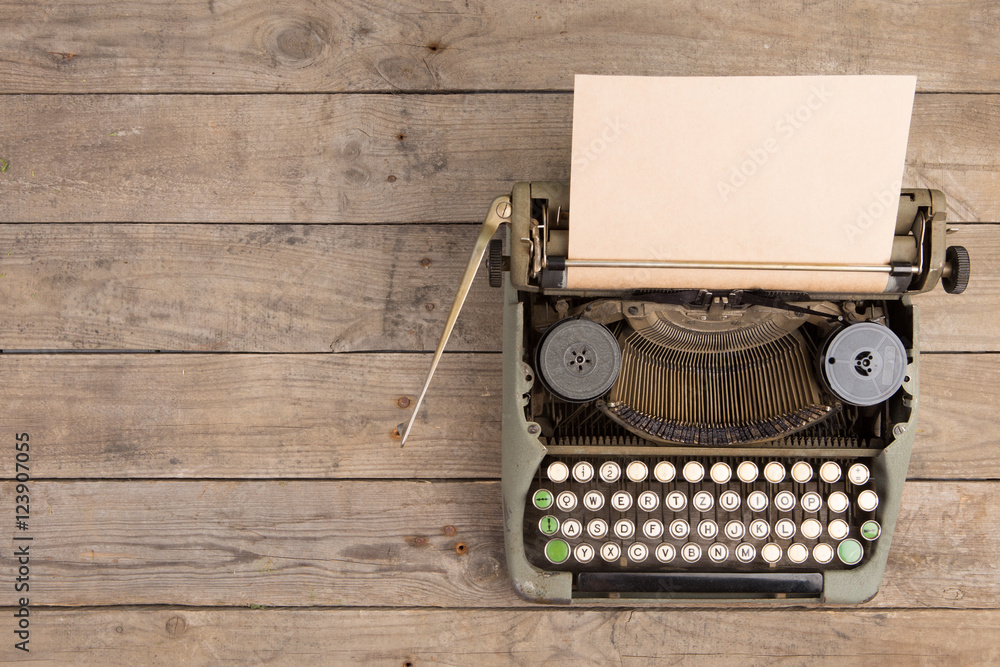 Vintage typewriter on the old wooden desk