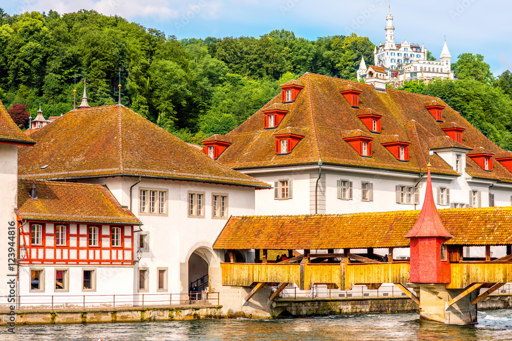 Ancient buildings with wooden roofs and bridge in Lucerne city in Switzerland