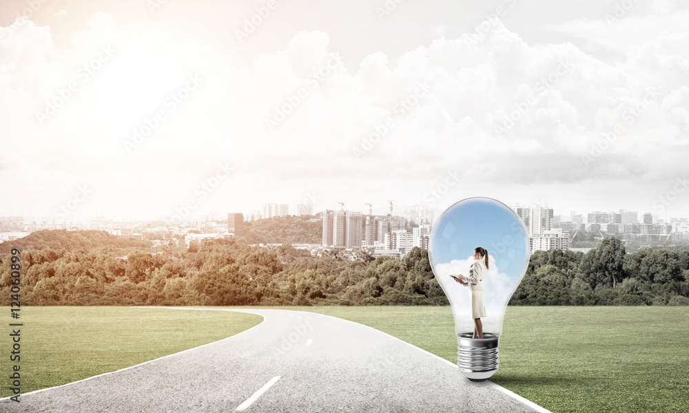 Businesswoman inside light bulb