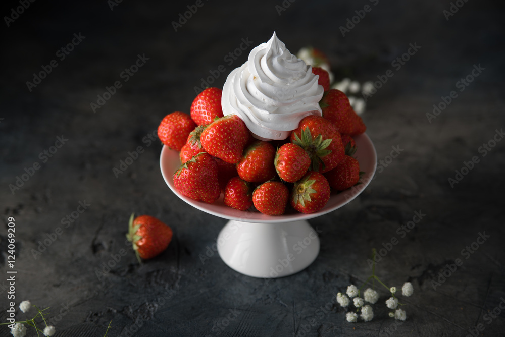 Fresh strawberries with whipped cream, frozen yogurt on a dark background