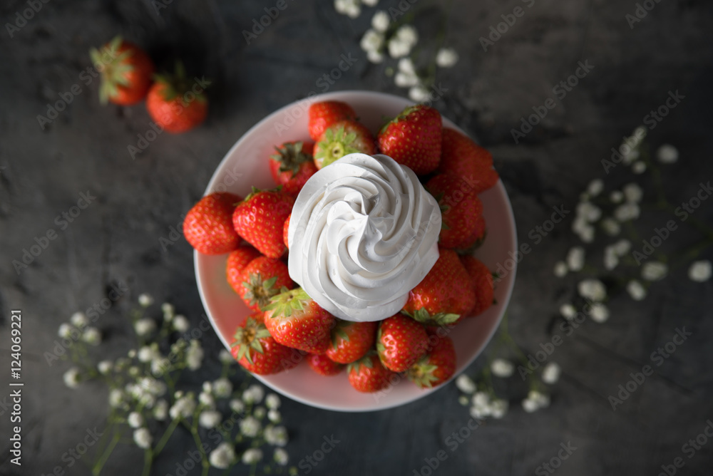 Fresh strawberries with whipped cream, frozen yogurt on a dark background. Top view.