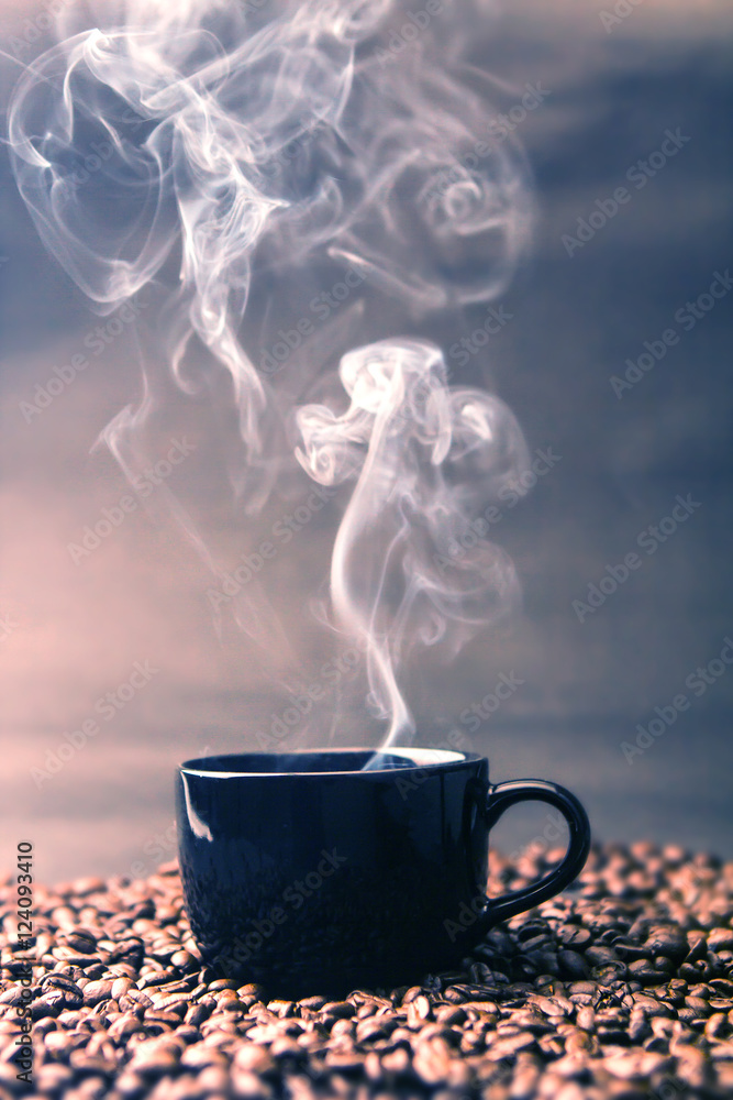 still life of warm black cup of coffee on  roasted coffee beans