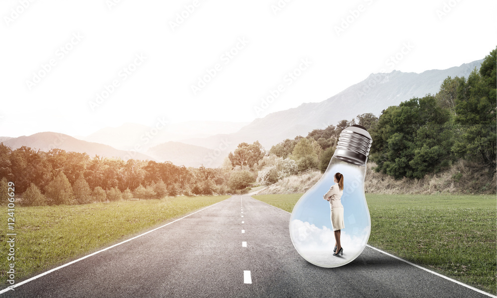 Businesswoman inside light bulb