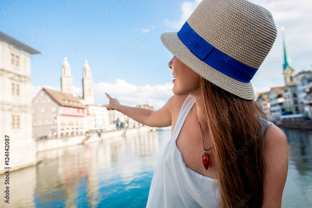 Female tourist enjoying cityscape view on the old town of Zurich city. Woman having happy vacations 