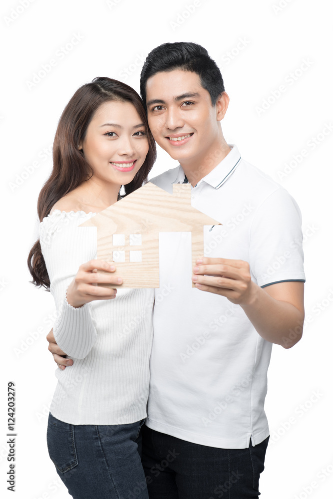 Loan concept. Young couple holding a white miniature house