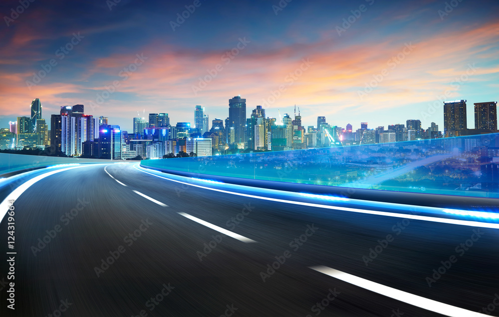 Blue neon light highway overpass motion blur with city  skyline background , night scene .