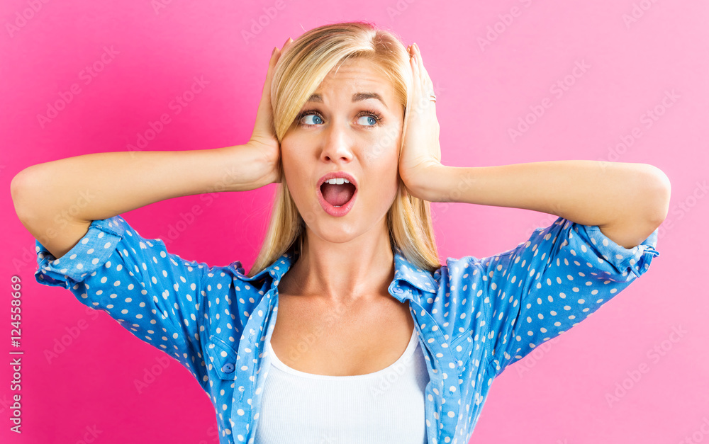 Young woman blocking her ears