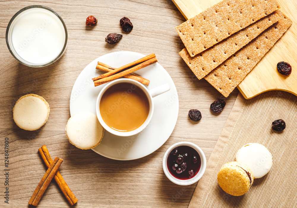 Breakfast with coffee, crackers and croissants on wooden table