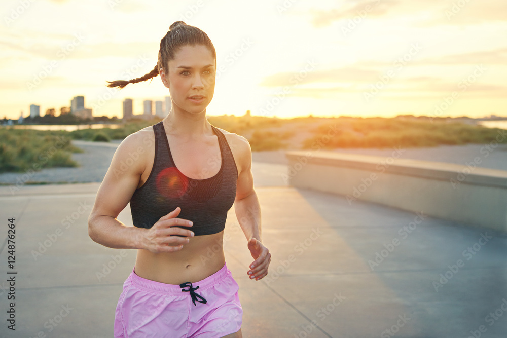 Beautiful and toned female jogger running