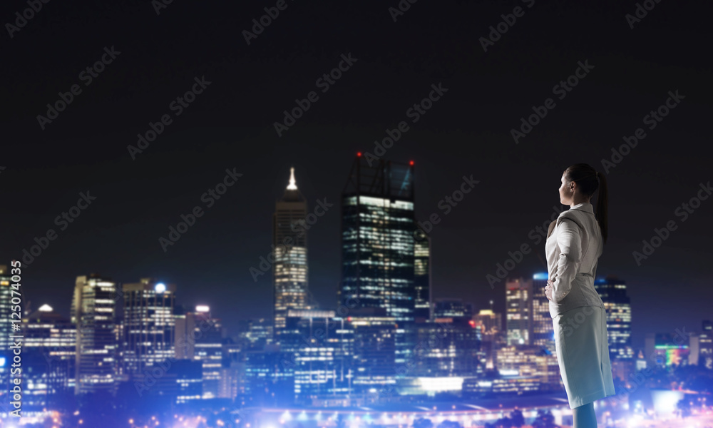 Woman looking at night city