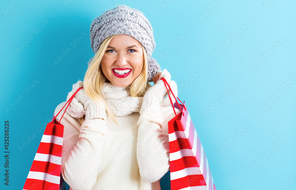 Happy young woman holding shopping bags