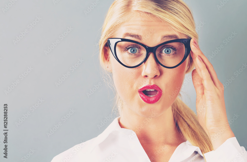 Young blonde businesswoman in black glasses