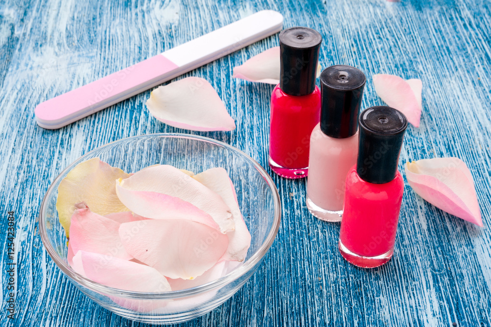 color nail polish with manicure set on blue background