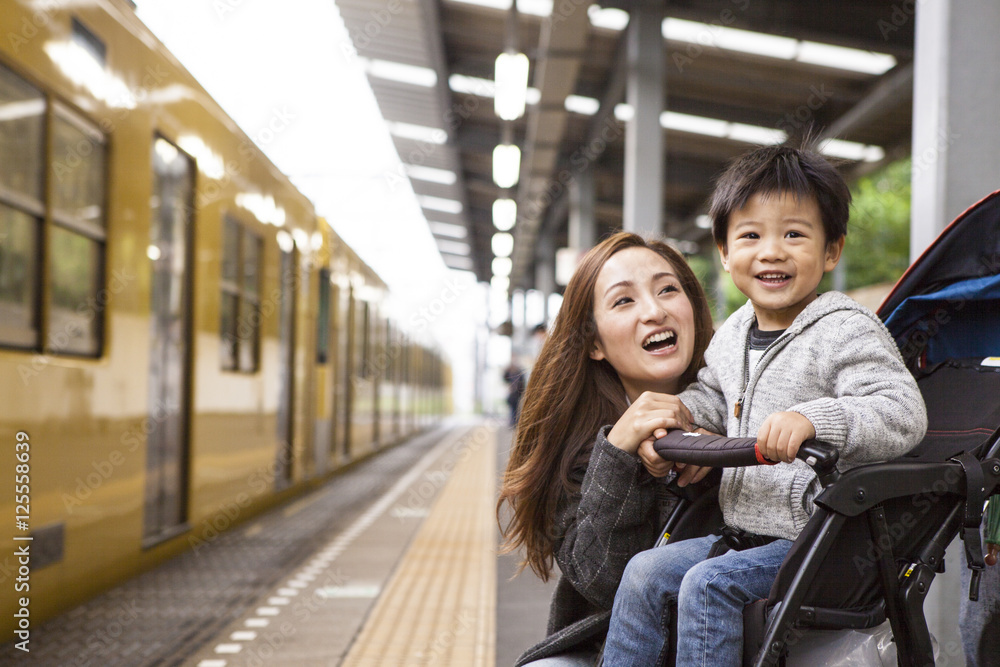 Parents and children are waiting for a train on the platform