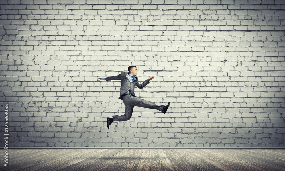 Businessman jumping high