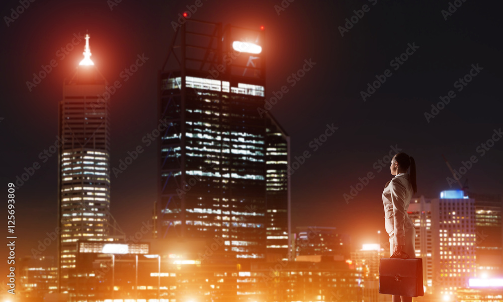 Woman looking at night city