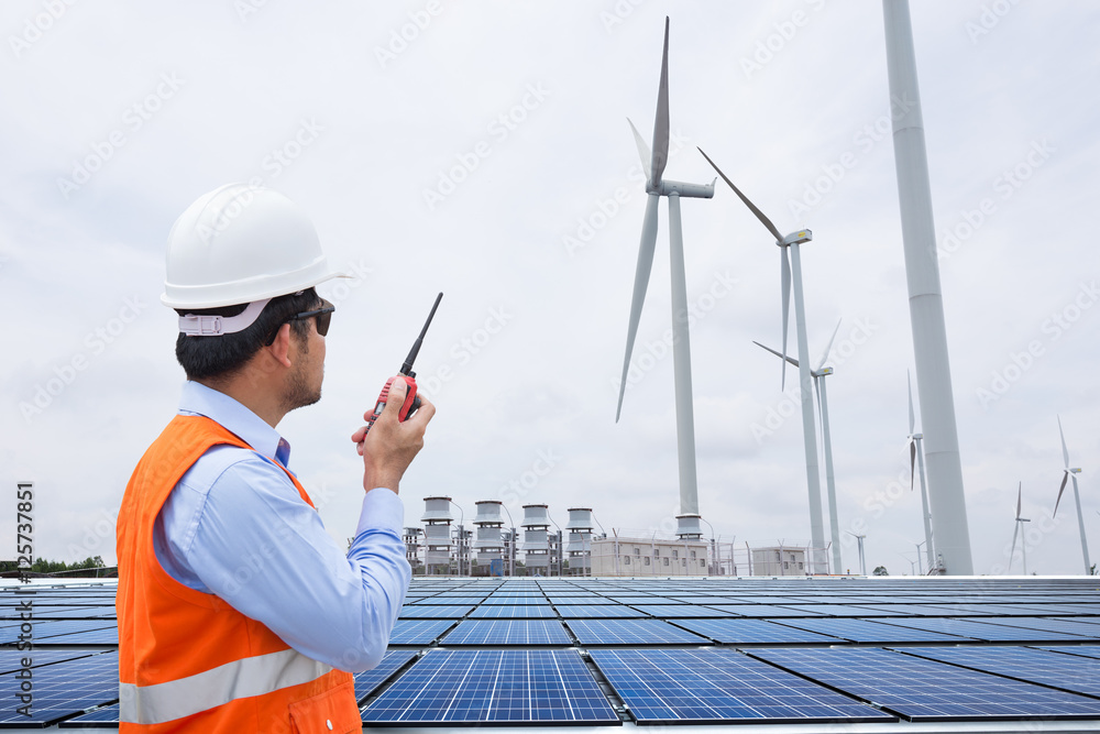 Engineers working at wind turbine power generator station