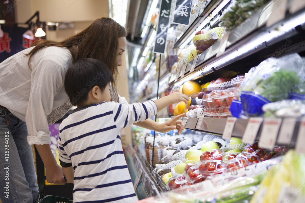 Mother and son have been shopping in the supermarket